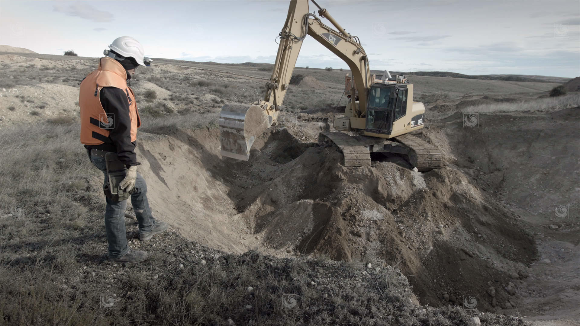 Videoframe showing excavation work fior the decontamination of soil with explosives